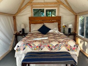 This charming tent has a queen size bed and windows to let in the evening breeze.