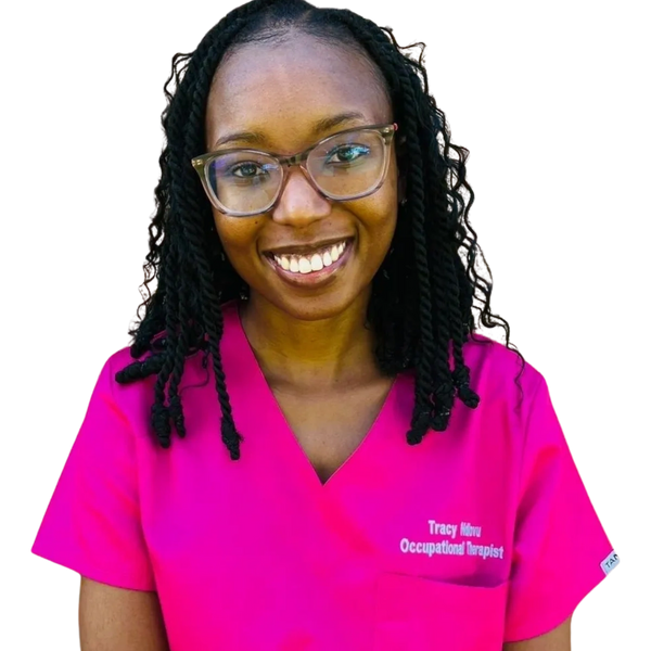Smiling woman in bright pink occupational therapist scrubs and glasses.