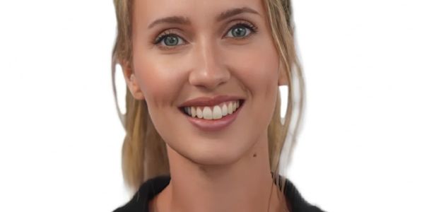 Close-up portrait of a smiling young woman with light eyes and blonde hair.