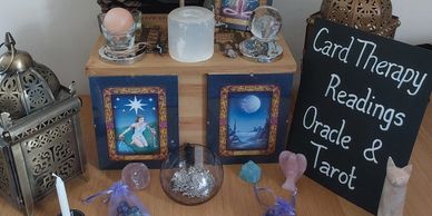 Card therapy readings with crystals and candles.