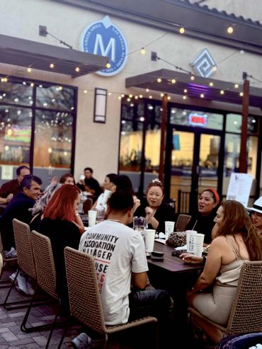 Group enjoying outdoor dining at a restaurant.