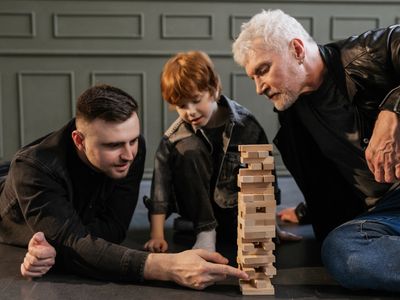 child, father, and grandfather playing a game together