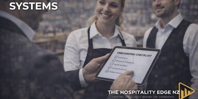 Team reviewing onboarding checklist in hospitality setting.