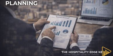 Business meeting focused on planning with charts and graphs.