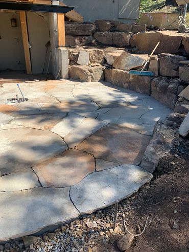 Flagstone patio. Boulder walls