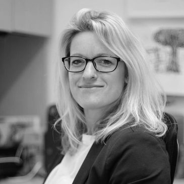 Blonde hair caucasian woman smiling with black glasses