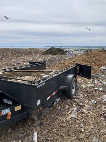 Dump trailer loaded with wooden debris at a landfill