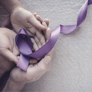 Three hands holding purple epilepsy awareness ribbon