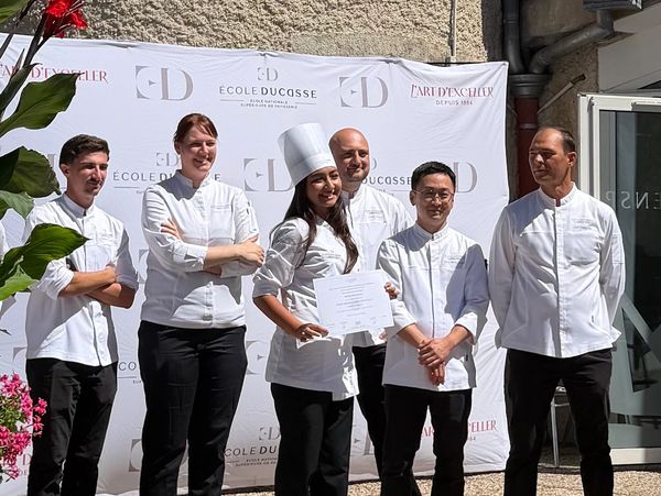 Group of chefs posing with a certificate.