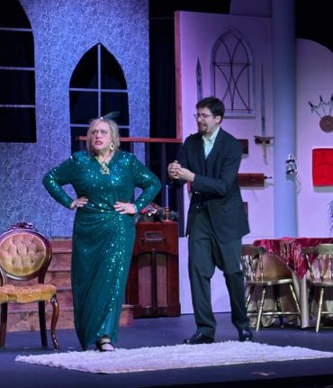 Actors perform a dramatic scene on a vintage-themed stage set.