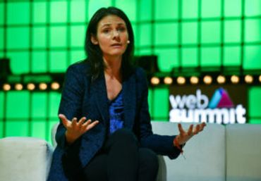 Woman speaking on stage at Web Summit event.