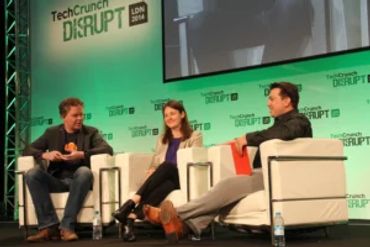 Three panelists discussing on stage at TechCrunch Disrupt London 2014.