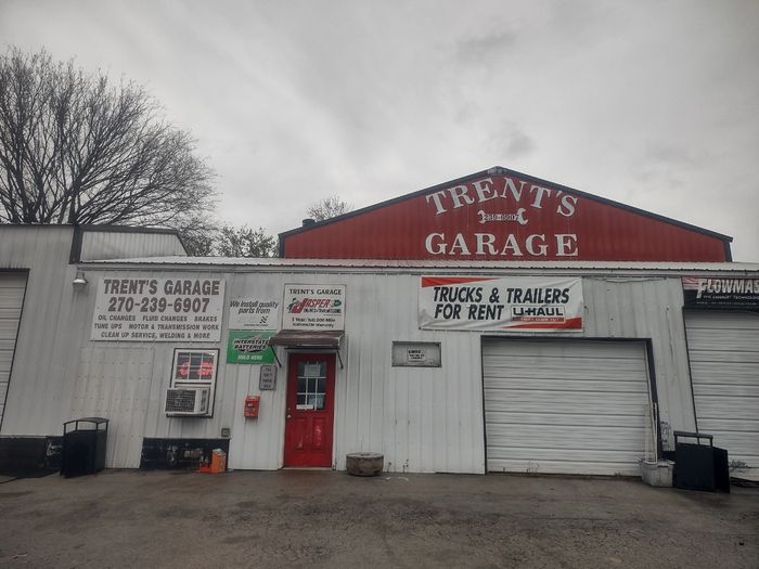 Exterior of Trent's Garage with signs for auto services and U-Haul rentals.