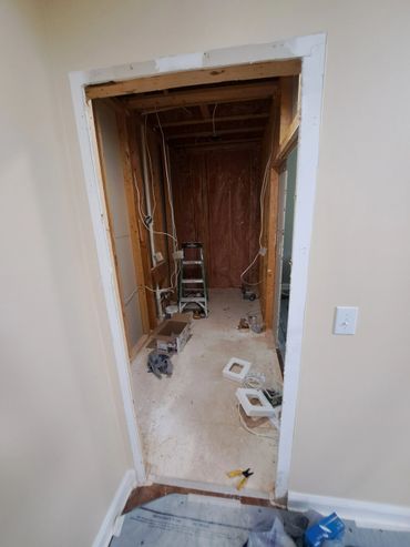 Room under construction with exposed studs and electrical wiring.