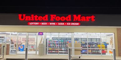 Front view of United Food Mart at night.