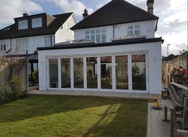 Modern glass extension on a suburban house.