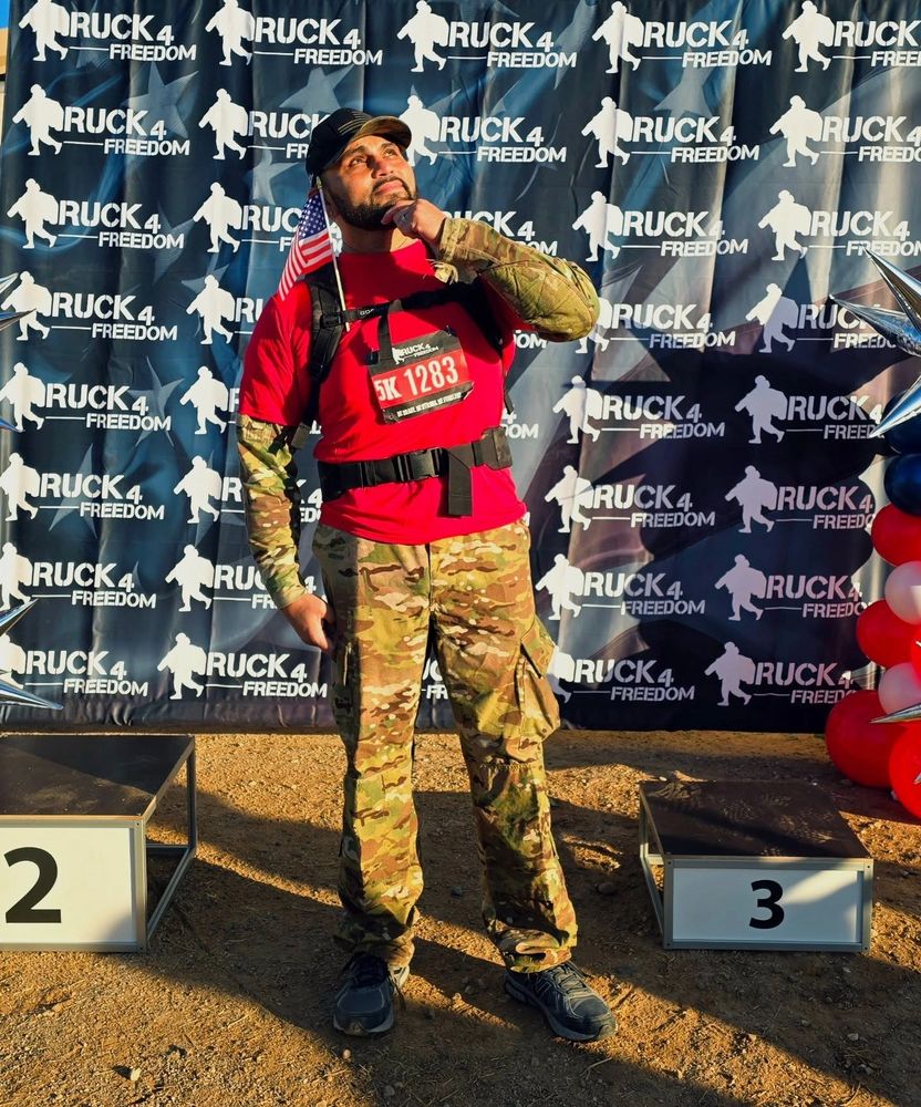 Man in military attire posing thoughtfully at Ruck 4 Freedom event.