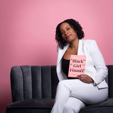 Selina Flavius -holding book black girl finance lets talk money
