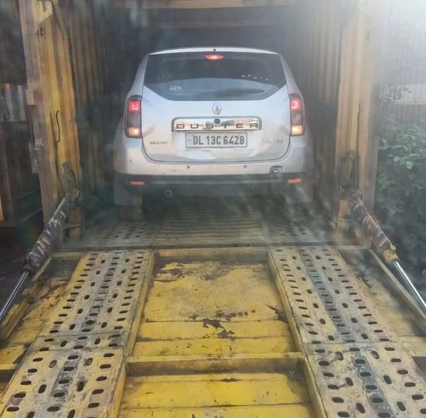Silver Renault Duster inside a yellow vehicle transport container.