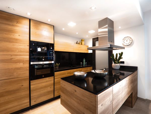 Modern kitchen with wooden furniture with incorporated appliances