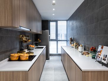 A modern kitchen with dark blue wall tiles and oak furniture