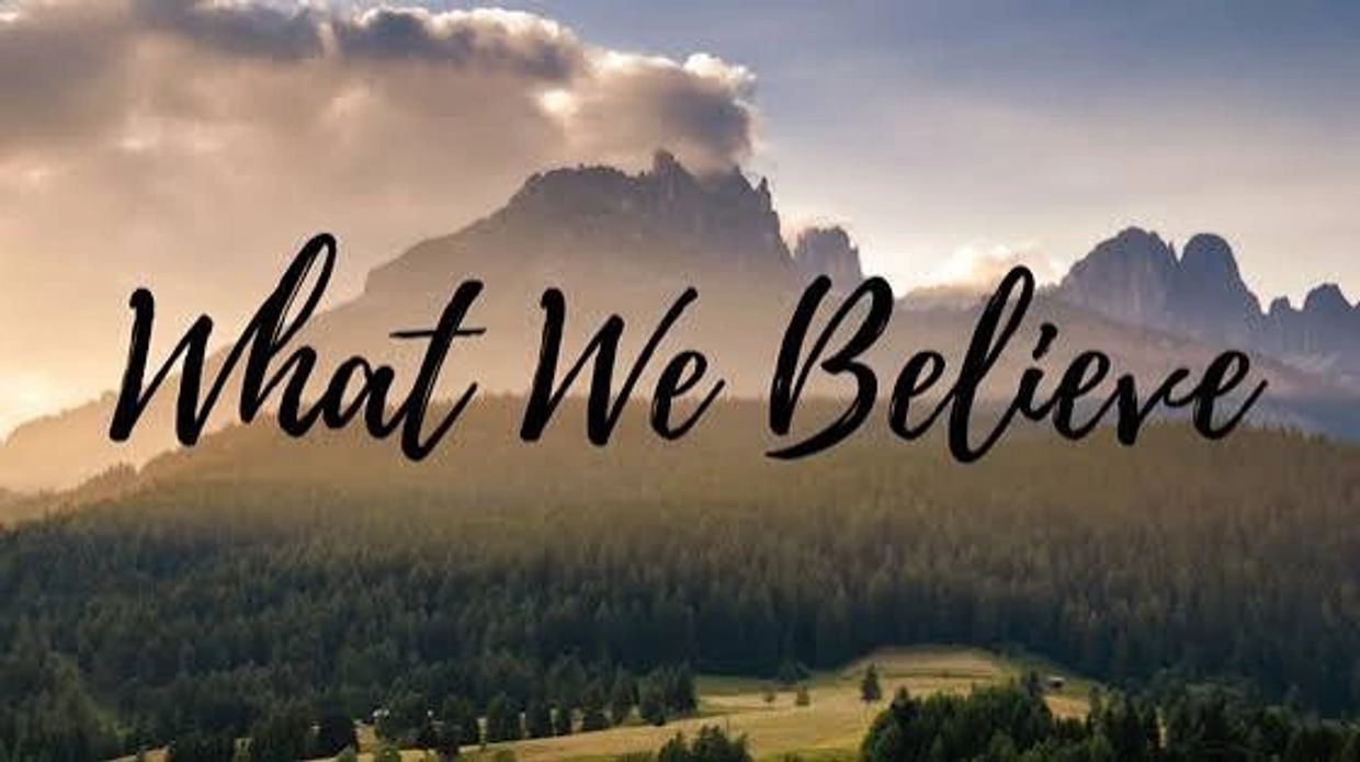 Text overlay on scenic mountain view: What We Believe