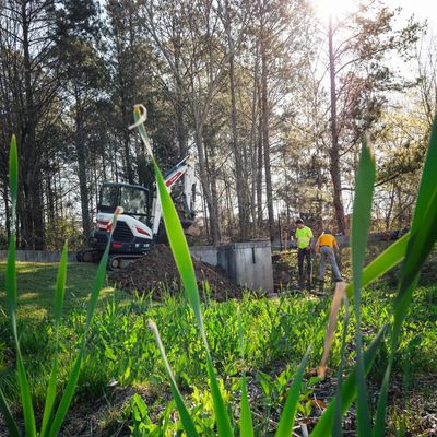 A neglected stormwater pond undergoing much needed maintenance by the Bishop's Land Service crew.