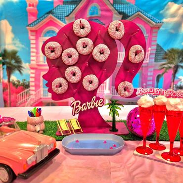 pink donuts on a barbie stand