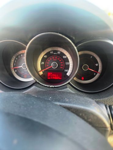Car dashboard showing speedometer, fuel gauge, and warnings.