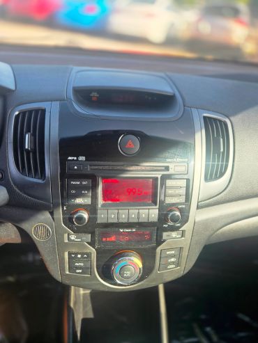 Car dashboard with radio and climate controls.