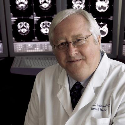 A man doctor sit on Chair and looking front