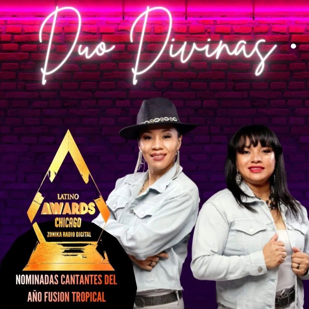 a female duo posing for an award