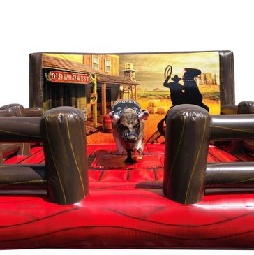 Mechanical bull ride set in a Wild West themed inflatable arena.