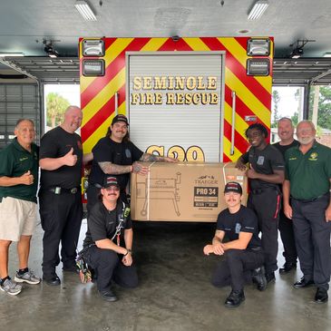 Brothers Tom Marrah and Tony Romano present a gift from Knights of Columbus 17162 of a Traeger Smoke