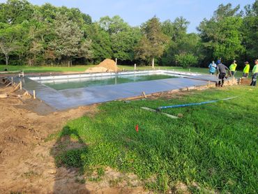 6th Step, Cement is poured and the crew is finalizing the cement to let it cure appropriately.