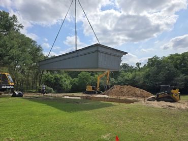 4th Step, Crane lifts pool shell and drops it into the hole in the ground.