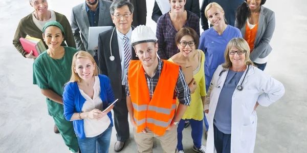 Groupe diversifié de professionnels souriants de différents secteurs.