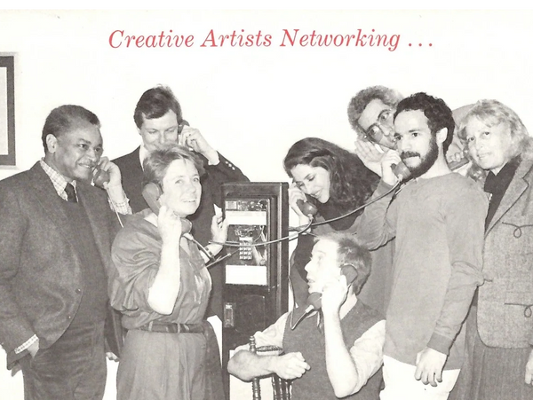 Humorous photo with several people around a pay telephone, caption "Creative Artists Networking..."