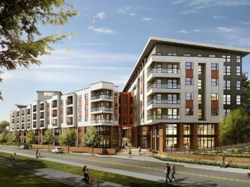 Modern apartment complex with greenery and people walking nearby.
