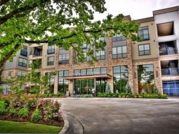 Modern apartment building with green landscaping.