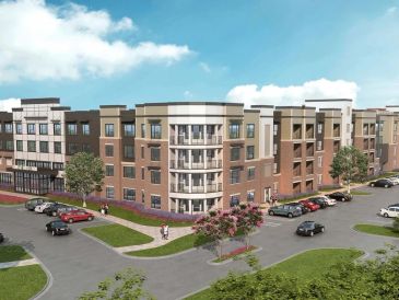 Modern residential apartment complex with parking and landscaping.