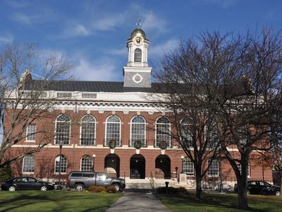 Historic brick courthouse with a clock tower under a clear blue sky.
