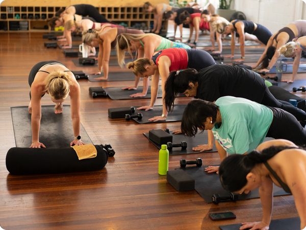 Members taking part in a Mat Pilates class at SOBA West End, building strength and endurance in a welcoming group studio environment.