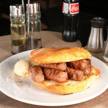 Grilled beef links - Ćevapi in home made bun with kajmak and onion