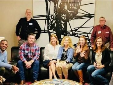 Kelly sitting with other members and passion for partnership sponsors of ATXPX