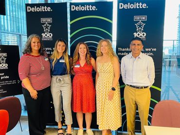 Kelly and Alison posing with three other members of ATXPX after ATXPX monthly meeting at Deloitte.