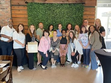 Kelly and several members of WilcoHR posing for a group photo after monthly meeting.