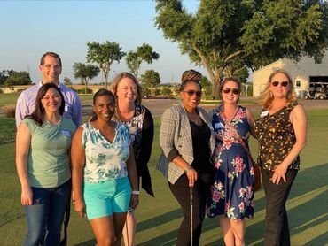 Picture of Kelly and six members of WilcoHR and a networking event on a golf course.