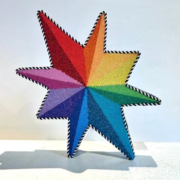 Dana's needlepoint rainbow star tree topper for Annie and Co NYC