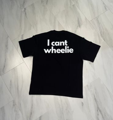 Black t-shirt with white text saying 'I cant wheelie'.
